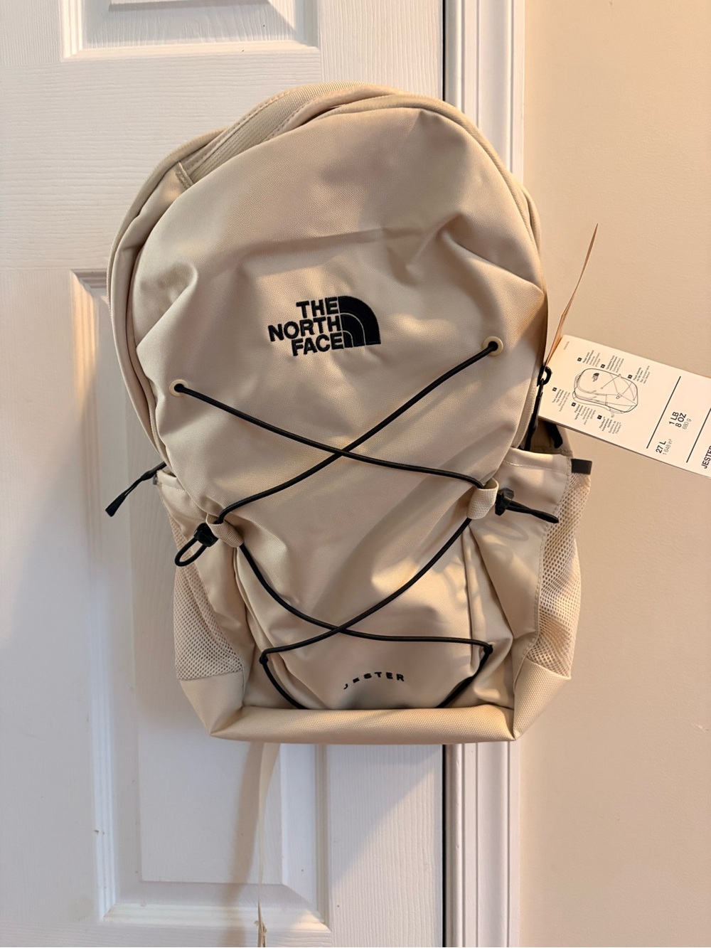The North Face Cream Backpack with Black Bungee Cord